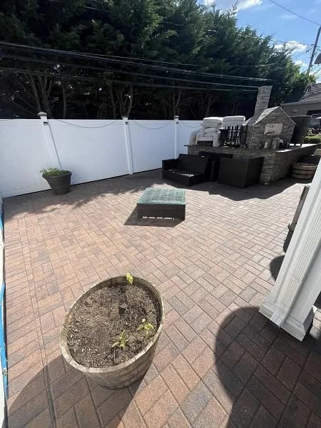 Backyard area with freshly sealed decorative pavers.