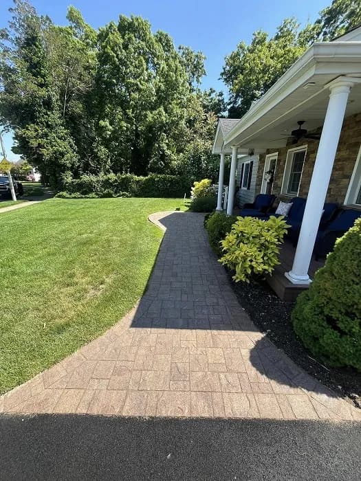 A stylish front yard patio with decorative pavers.