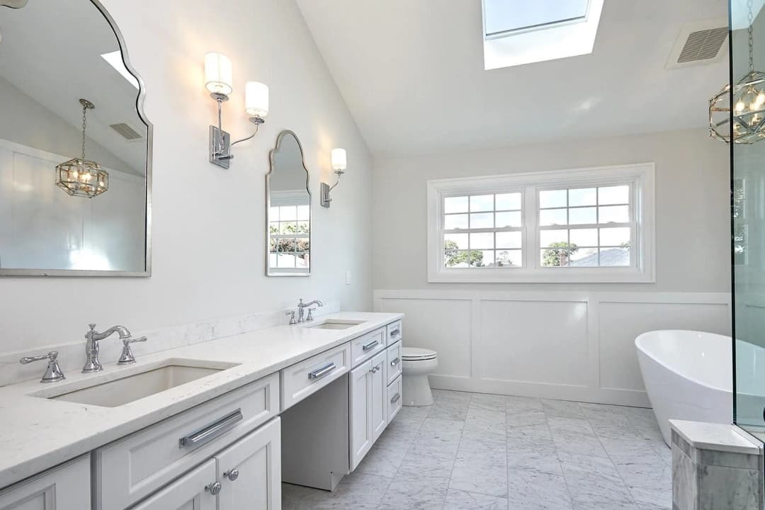 An elegant white bathroom with a modern and sleek design