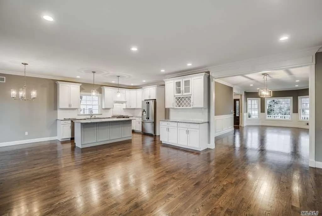 A full view of a spacious modern kitchen with high-end appliances.