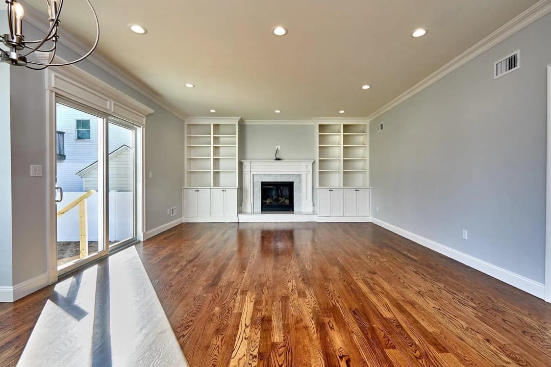 The interior of a modern living room with large windows.