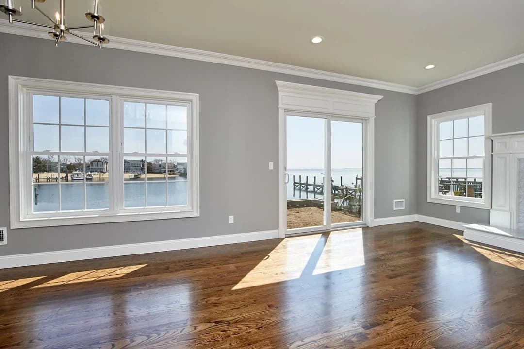A scenic view overlooking calm water from a beautifully designed interior space.