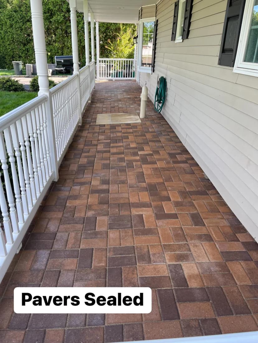 Freshly sealed pavers on a backyard patio.