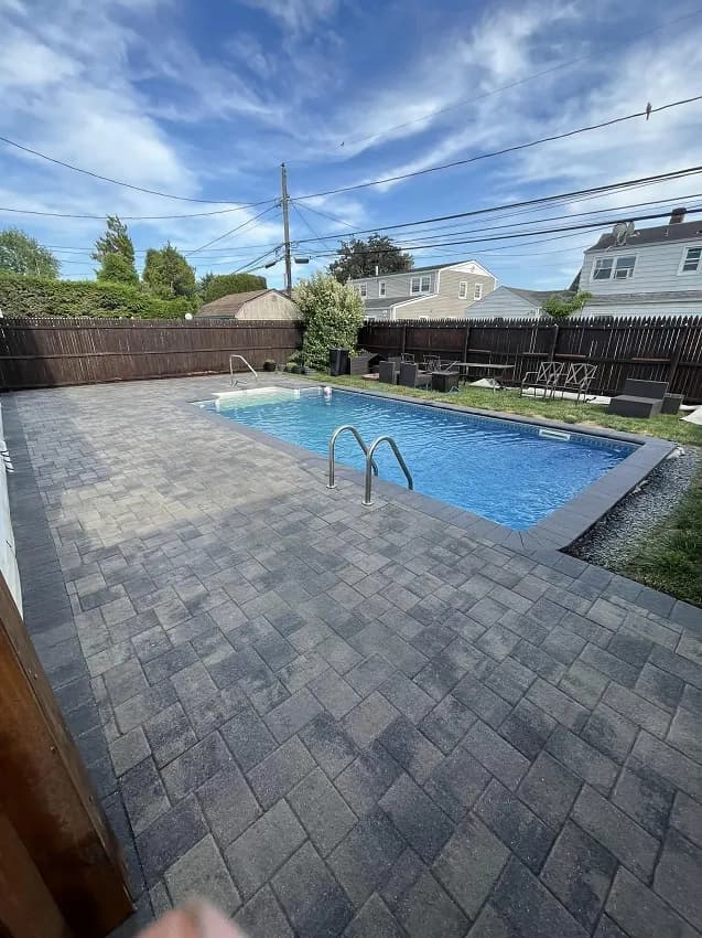 A beautiful backyard pool surrounded by a relaxing deck.