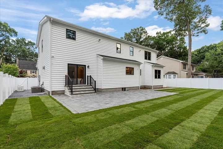 Beautiful backyard with pavers and siding
